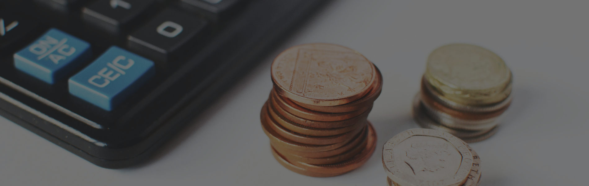 Stack of coins next to calculator