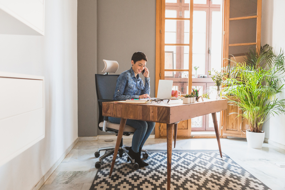 Woman at desk working from home on the phone