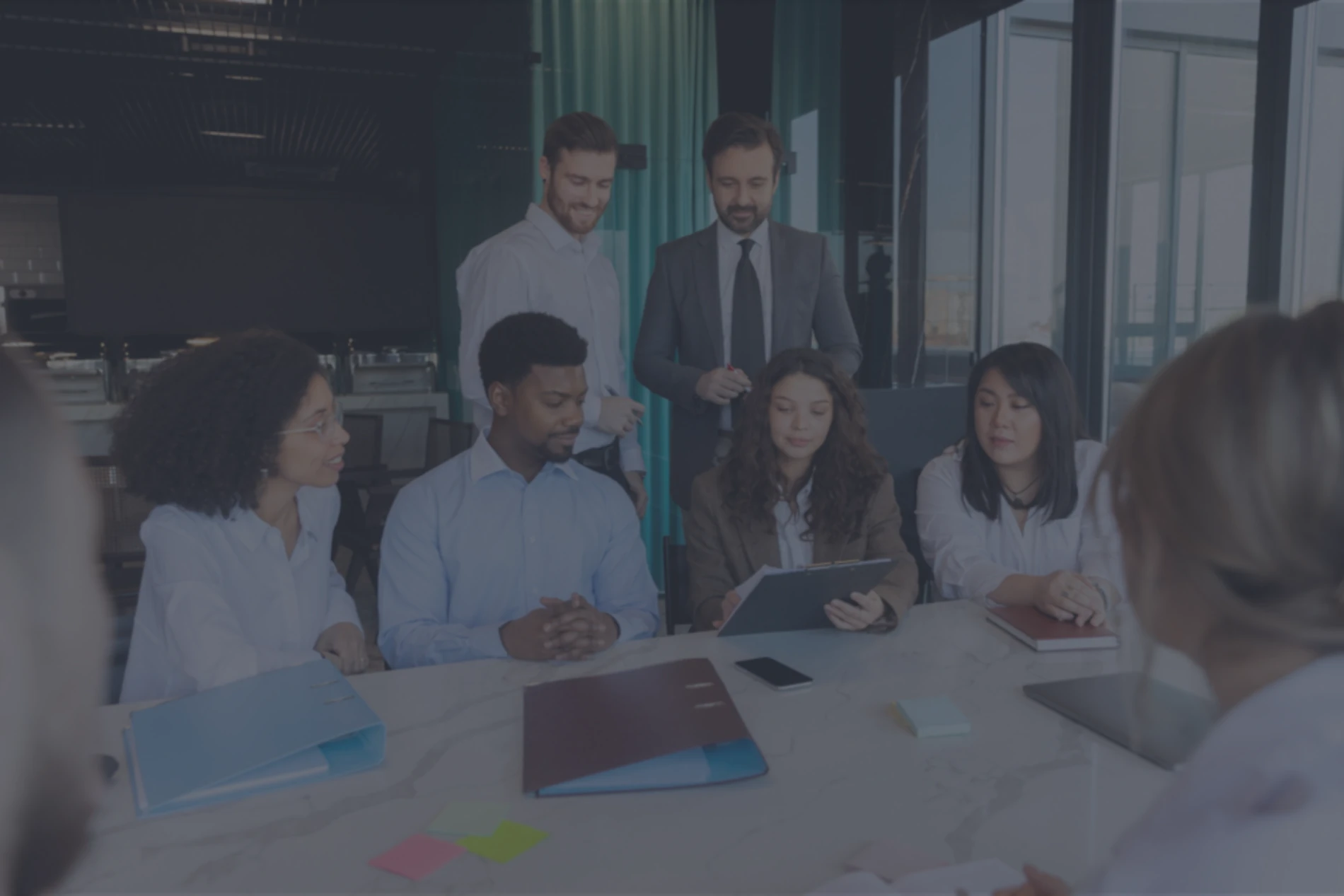 People sat in meeting with technology