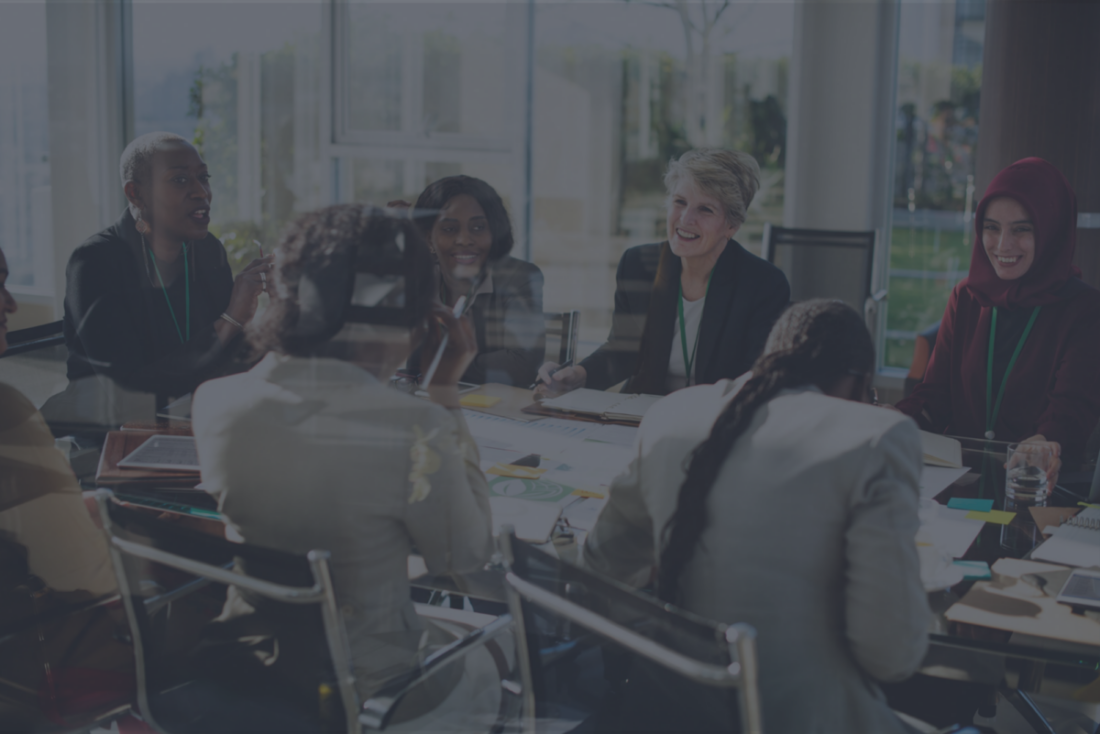 A Group of International Business Women are Laughing in a Meeting